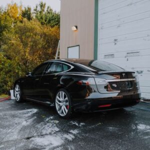 Black Tesla sedan with paint protection