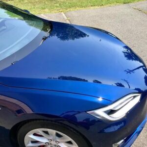 Front end of a Blue Tesla Model 3 ceramic coated