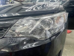 Toyota Camry headlight restoration process: PPF application