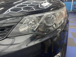 The Toyota Camry headlight is finished with a glossy look and PPF coating
