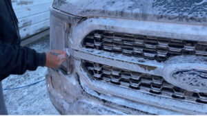 Washing the headlight of a Ford truck
