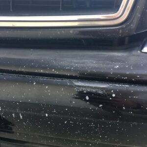Rock Chips and Chip Damage on the black paint of a car
